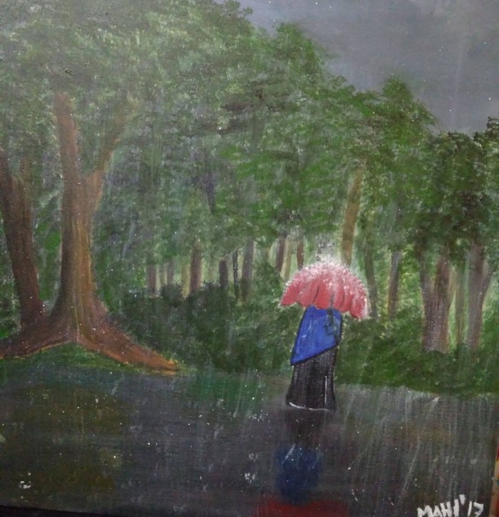 hijabi women holding an umbrella in rain